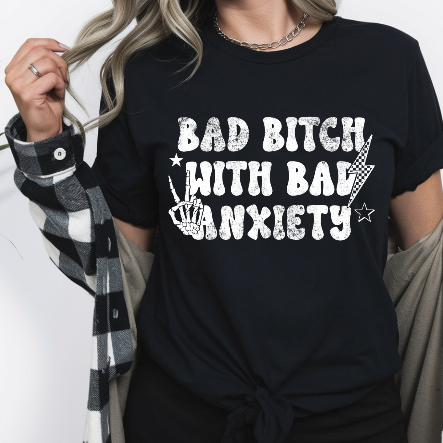 Black Bad Bitch with Bad Anxiety graphic tee with distressed white lettering, skeleton hand peace sign, stars, and checker lightning bolt