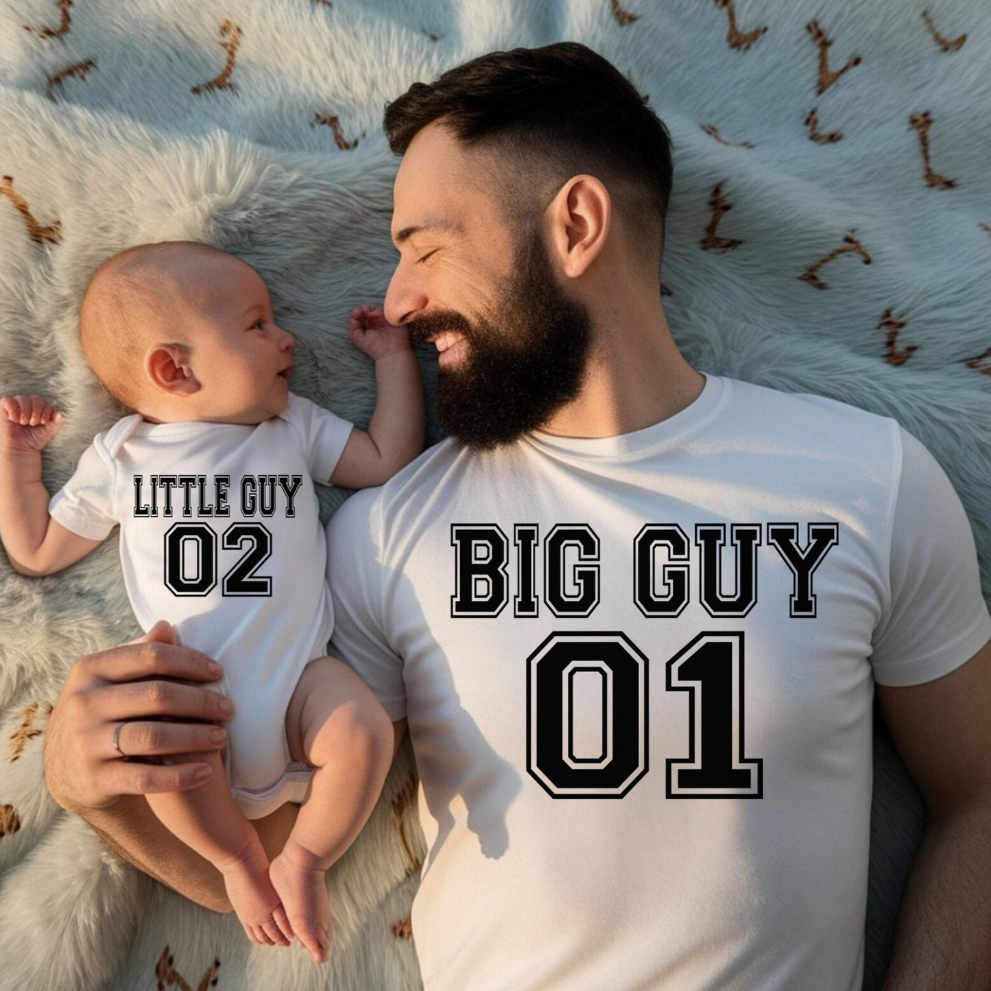 Matching father and son shirts featuring Big Guy 01 and Little Guy 02 varsity-style graphics on a dad tee and baby bodysuit.