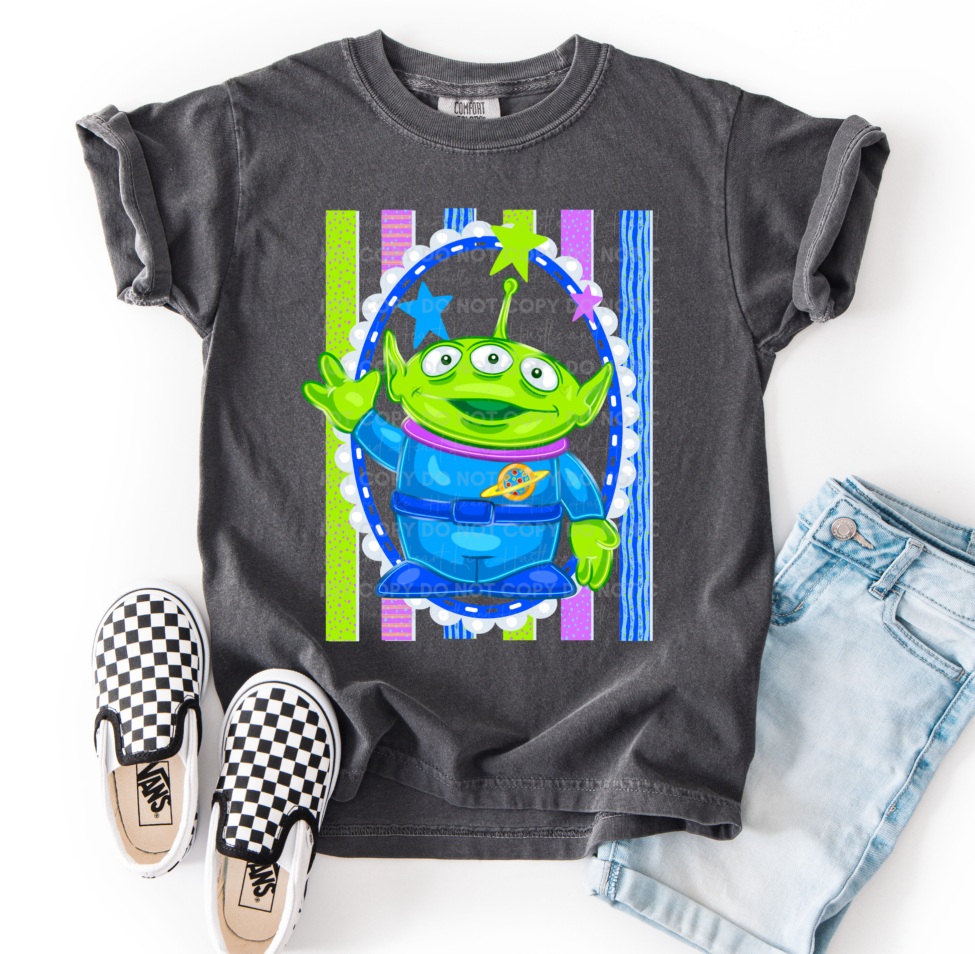 Alien-inspired Toy Story character design on a Comfort Colors® t-shirt featuring bright cosmic colors and playful details.