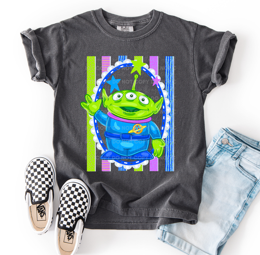 Alien-inspired Toy Story character design on a Comfort Colors® t-shirt featuring bright cosmic colors and playful details.