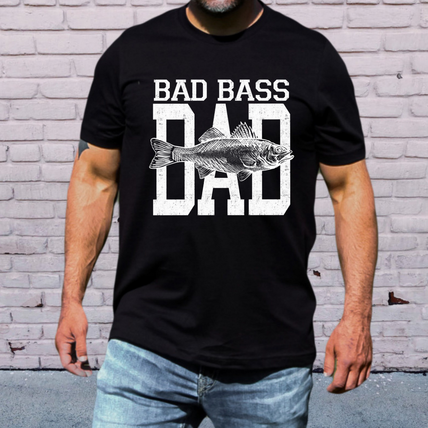 Bad Bass Dad fishing shirt featuring a vintage distressed text design with a detailed bass fish graphic on black  tee.