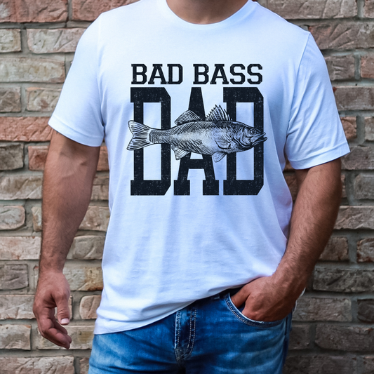 Bad Bass Dad fishing shirt featuring a vintage distressed text design with a detailed bass fish graphic on white tee.