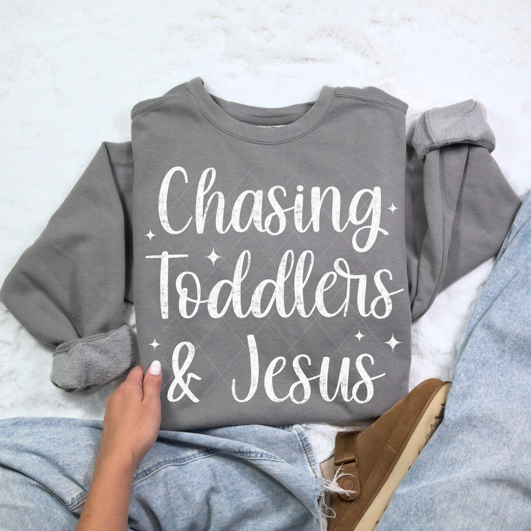 Chasing Toddlers & Jesus sweatshirt in Comfort Colors Gray — soft unisex crewneck displayed with rolled sleeves and denim jeans.