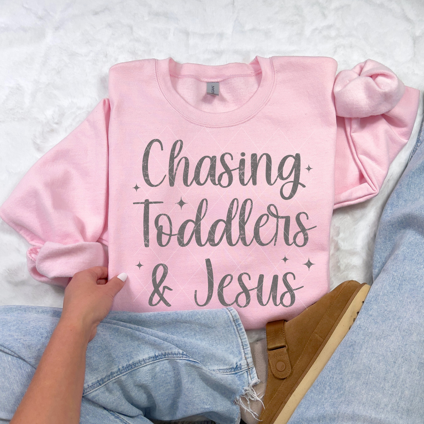 Chasing Toddlers & Jesus sweatshirt in Light Pink — feminine faith-based crewneck styled with jeans.