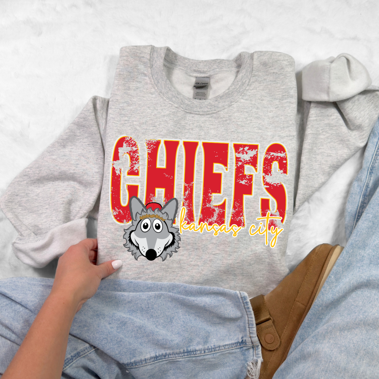Youth Ash Gray Chiefs sweatshirt with KC Wolf mascot and distressed lettering.