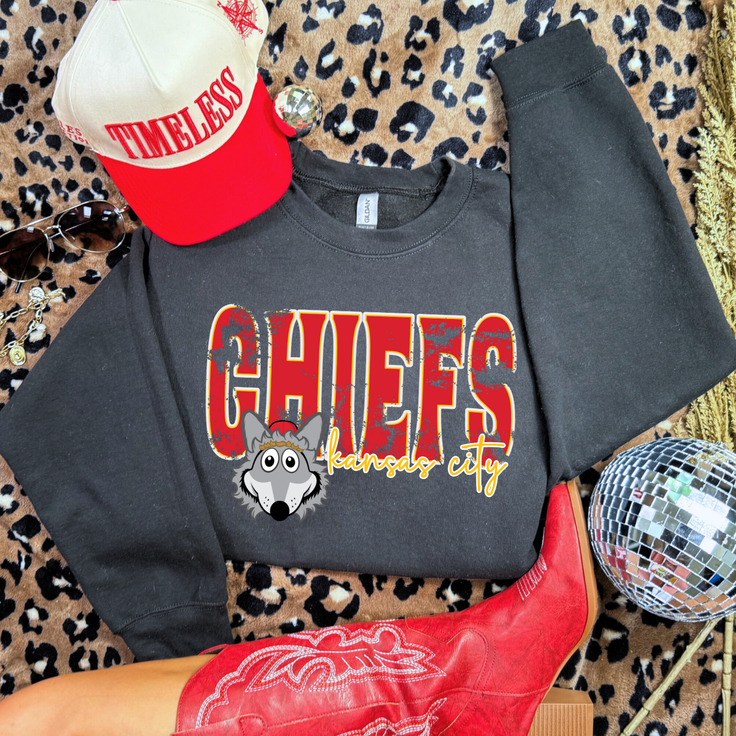 Youth Black Chiefs crewneck with Kansas City Wolf mascot graphic.
