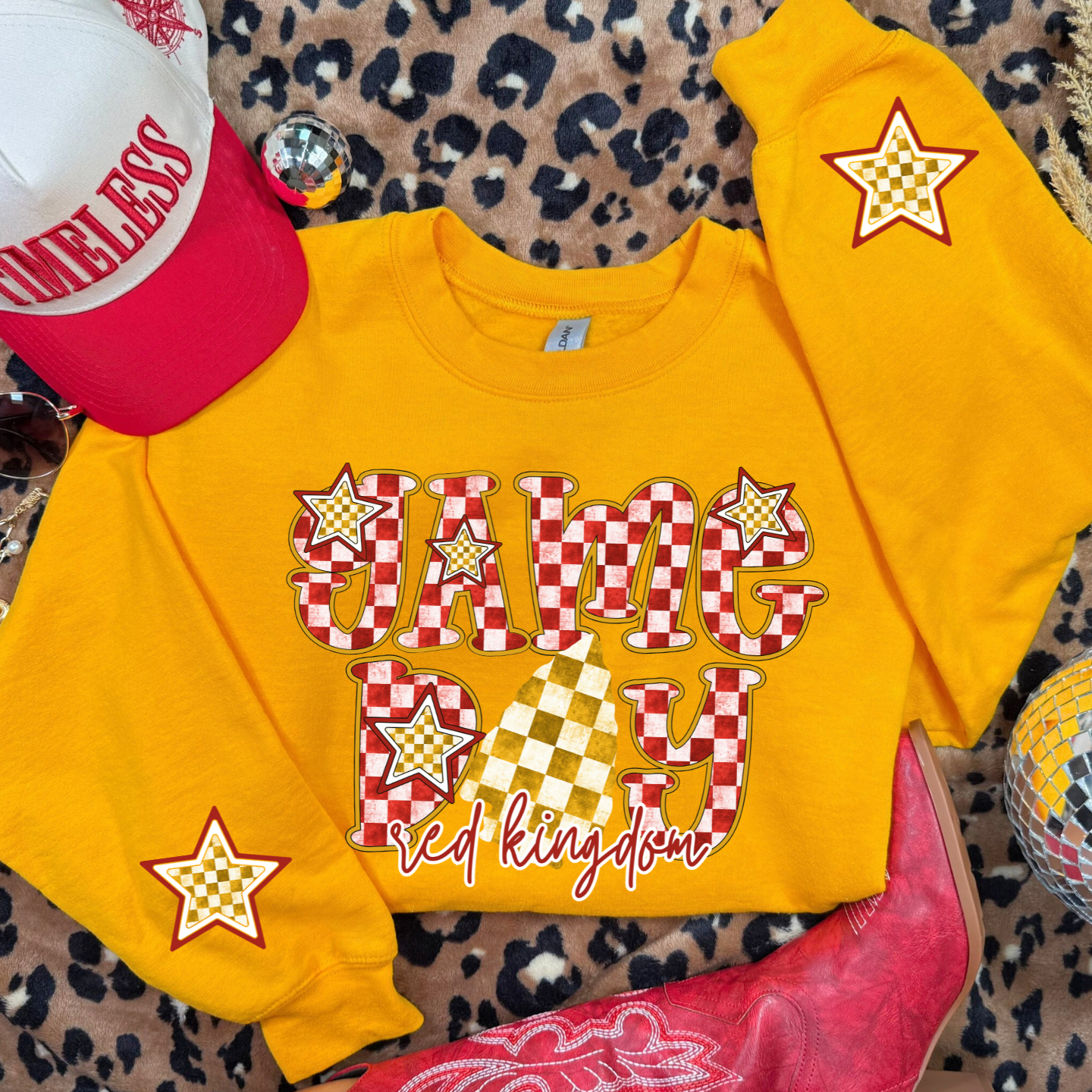 Gold Red Kingdom Game Day sweatshirt with checkered lettering and stars.