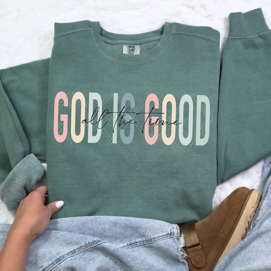 God Is Good All The Time sweatshirt in Comfort Colors Blue Spruce with pastel block letters and script overlay, styled with denim and tan slipper