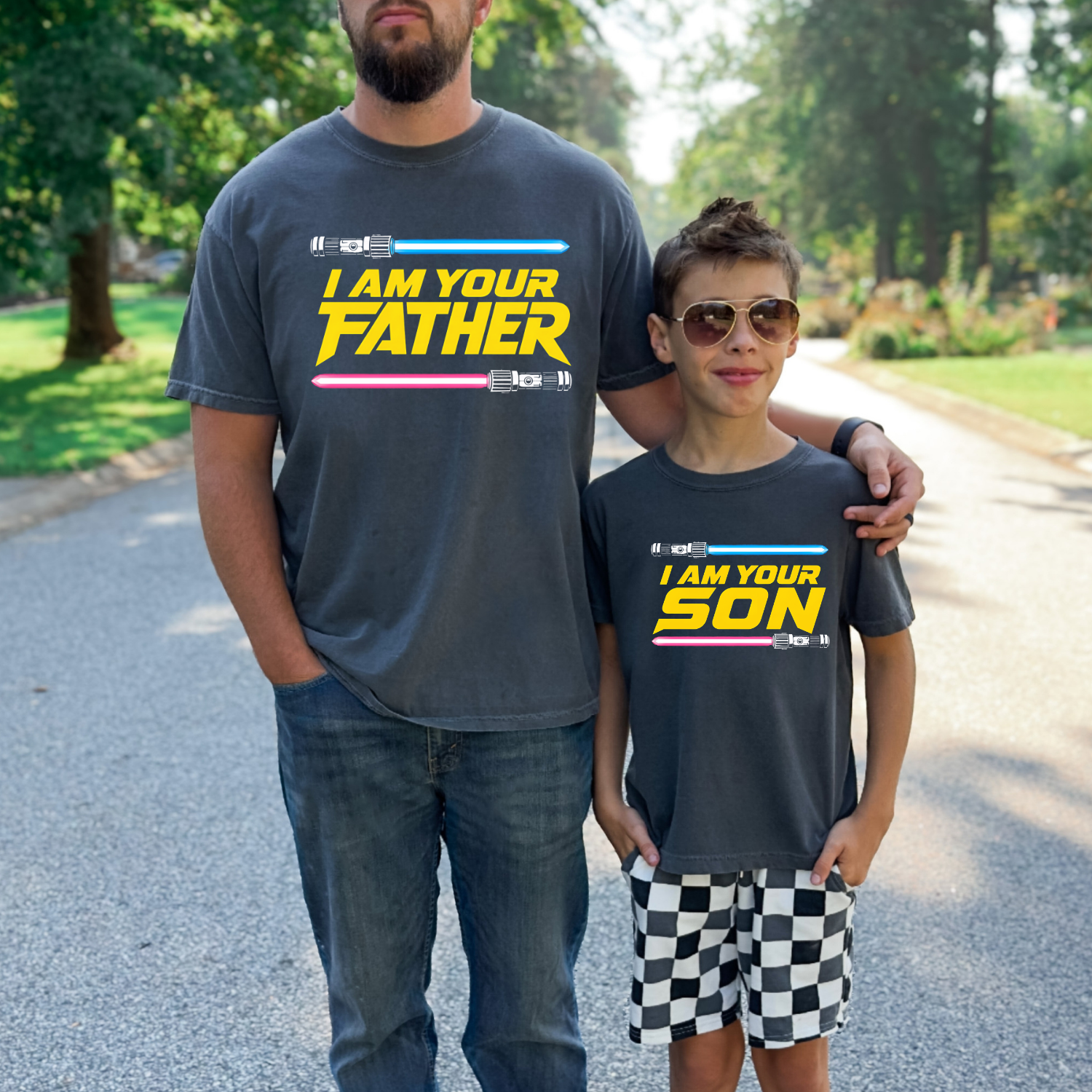Matching father and son shirts featuring "I Am Your Father" and "I Am Your Son" designs with colorful lightsabers and bold retro-inspired typography.