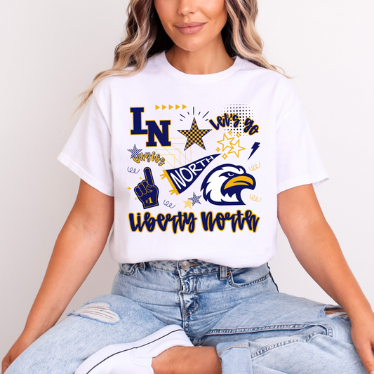 Person wearing a white Liberty North t-shirt with colorful graphics and spirit wear graphics, Eagles, Liberty North