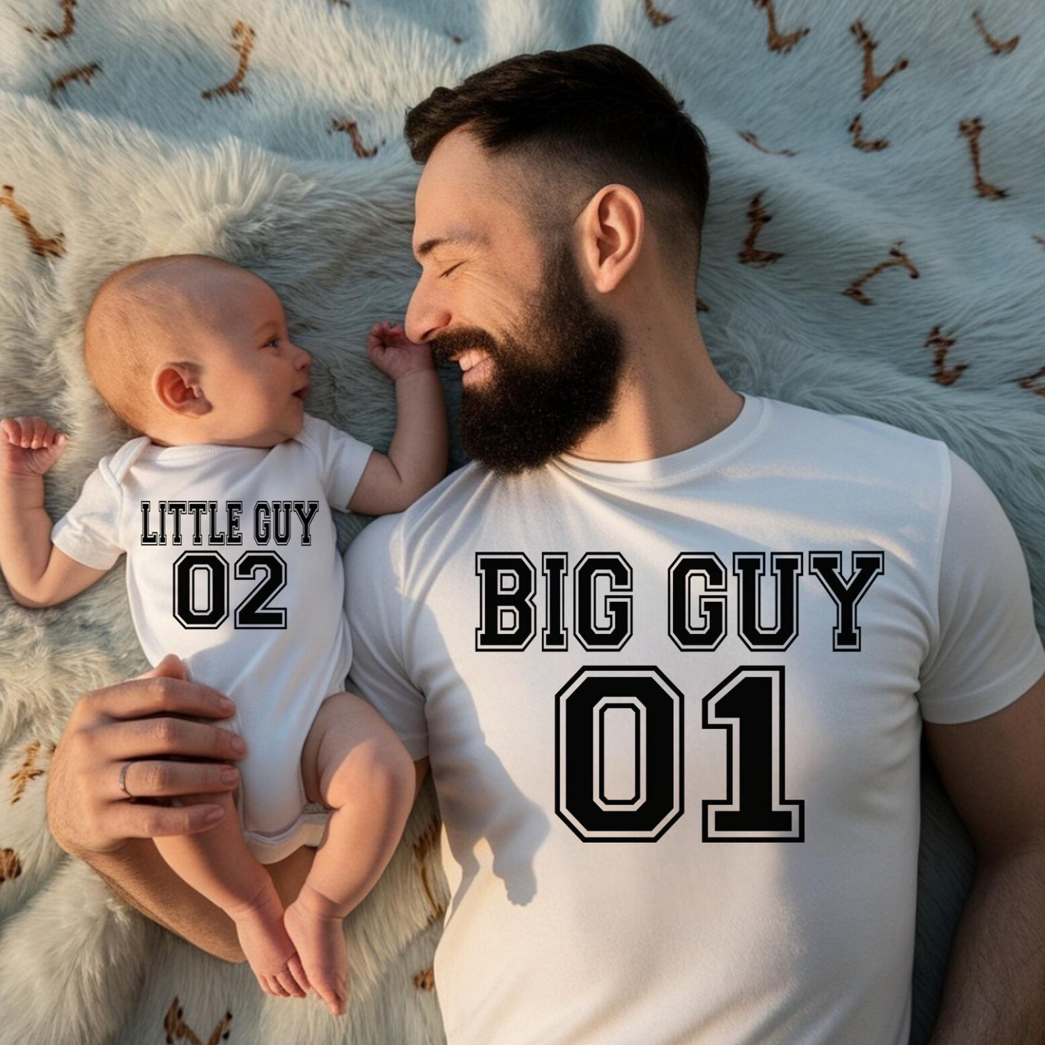Matching father and son shirts featuring Big Guy 01 and Little Guy 02 varsity-style graphics on a dad tee and baby bodysuit.