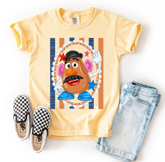 Mr. Potato Head-inspired character design printed on a Comfort Colors® t-shirt featuring colorful retro accents, stars, and playful details, perfect for Disney vacations and Toy Story fans.
