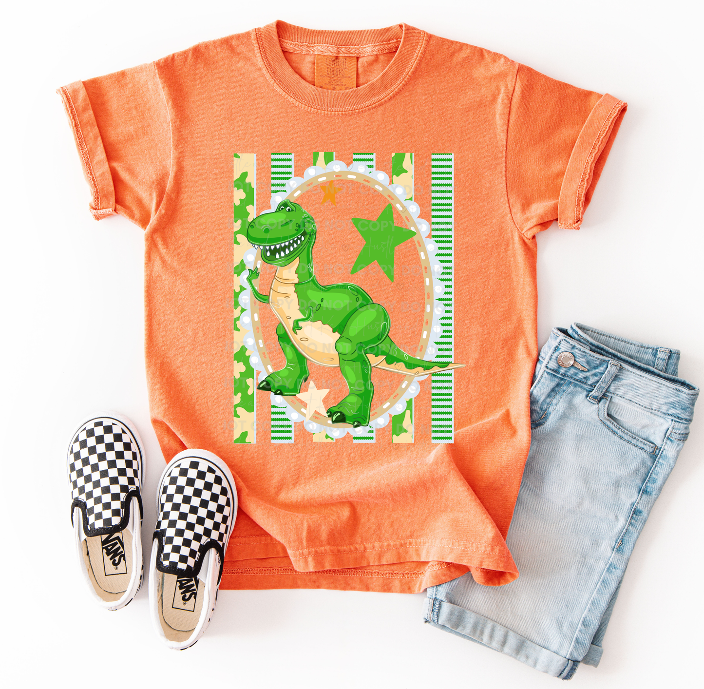 Rex-inspired dinosaur character design printed on a Comfort Colors® t-shirt with bright green accents and playful details.