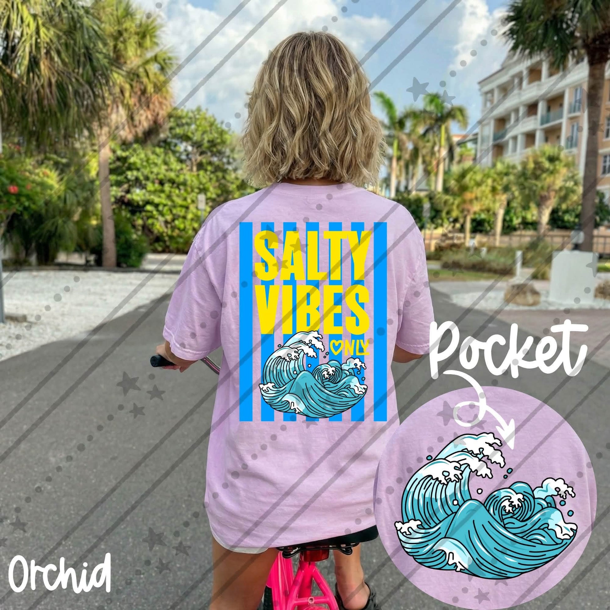 Comfort Colors graphic t-shirt featuring a colorful "Salty Vibes Only" wave design on the back with a matching ocean wave pocket graphic on the front. Available in orchid, chambray, chalky mint, and black.