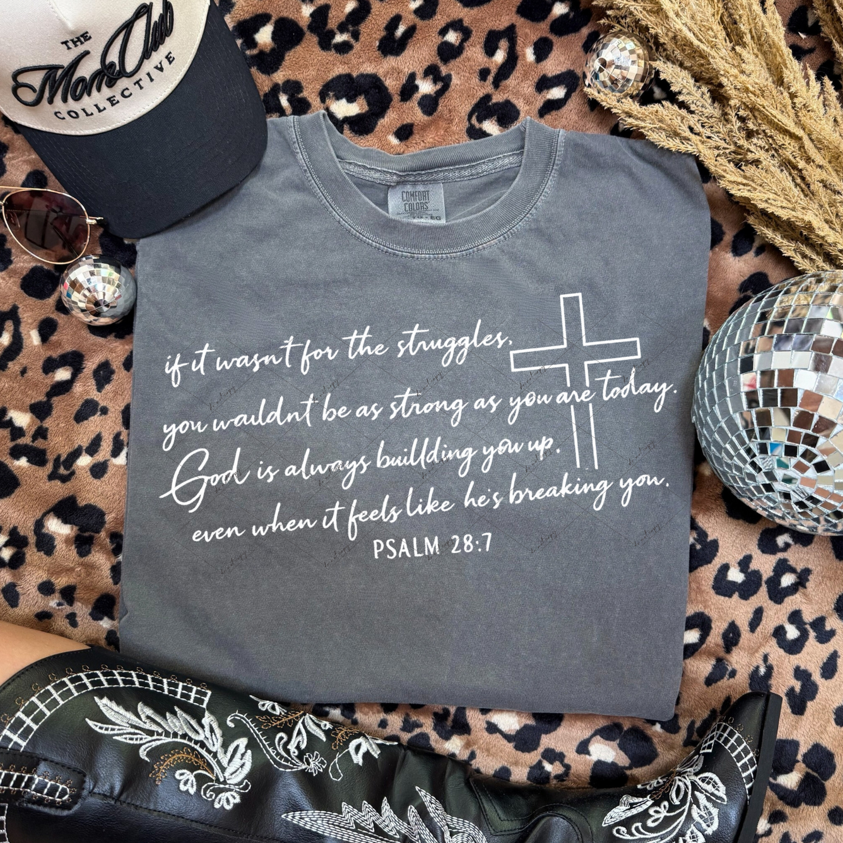 Pepper Comfort Colors t-shirt featuring Psalm 28:7 quote and cross line art, styled with western boots, hat, and disco ball.