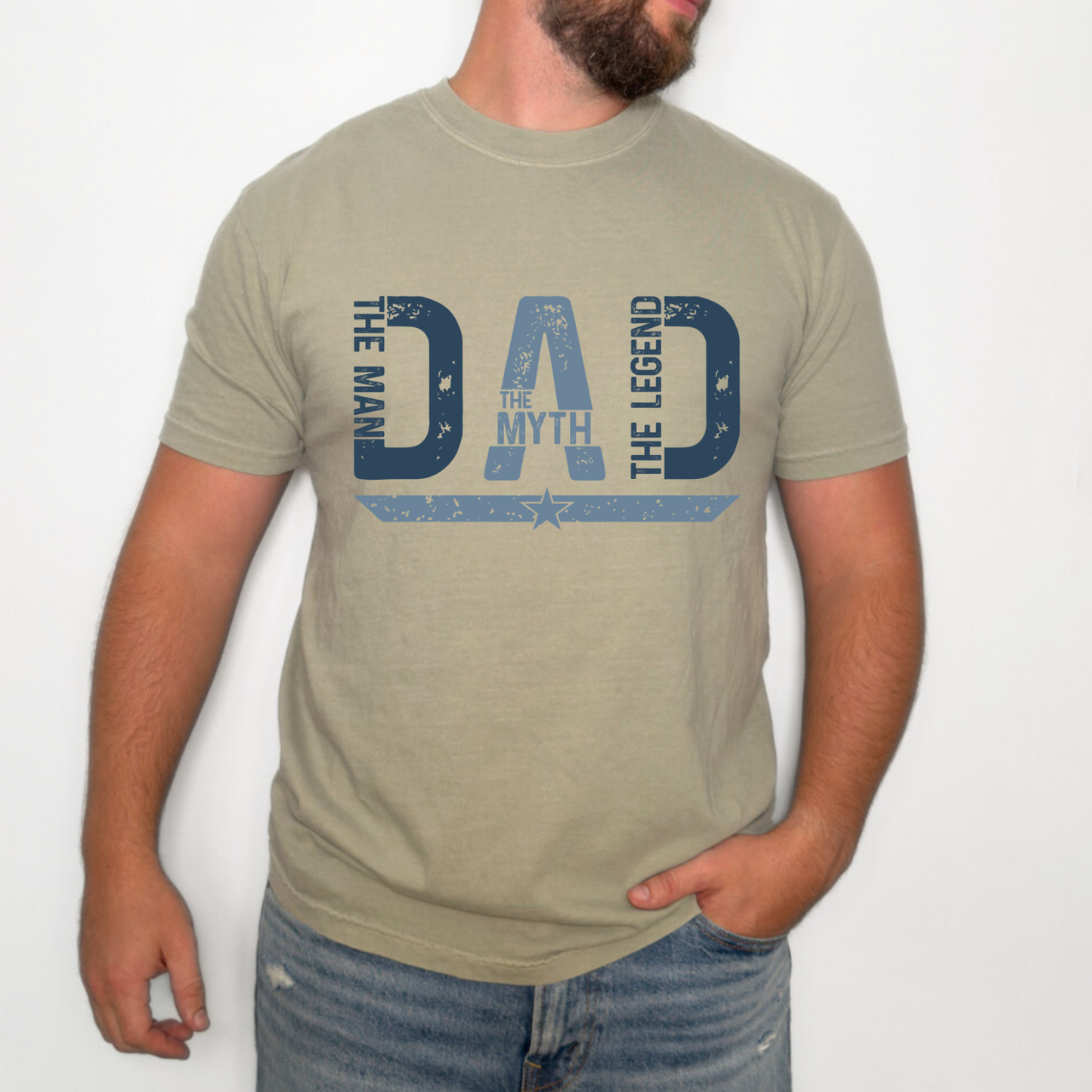 Vintage distressed "The Man The Myth The Legend Dad" graphic t-shirt displayed on white, sandstone, and cool gray shirts. Perfect Father's Day gift for dads.