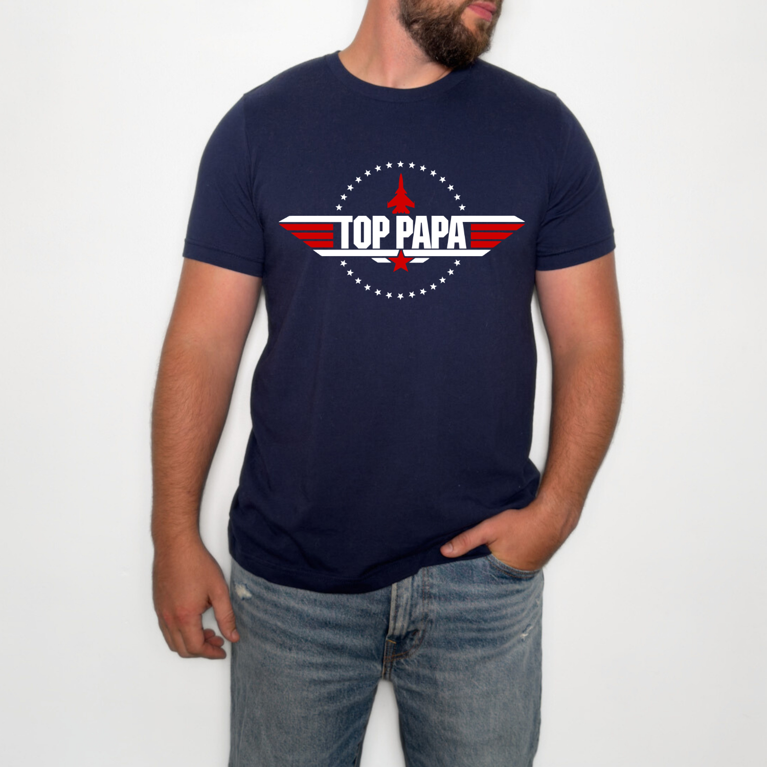 Top Papa patriotic aviation graphic t-shirt featuring a red white and blue military-inspired emblem with jet silhouette on navy shirt.
